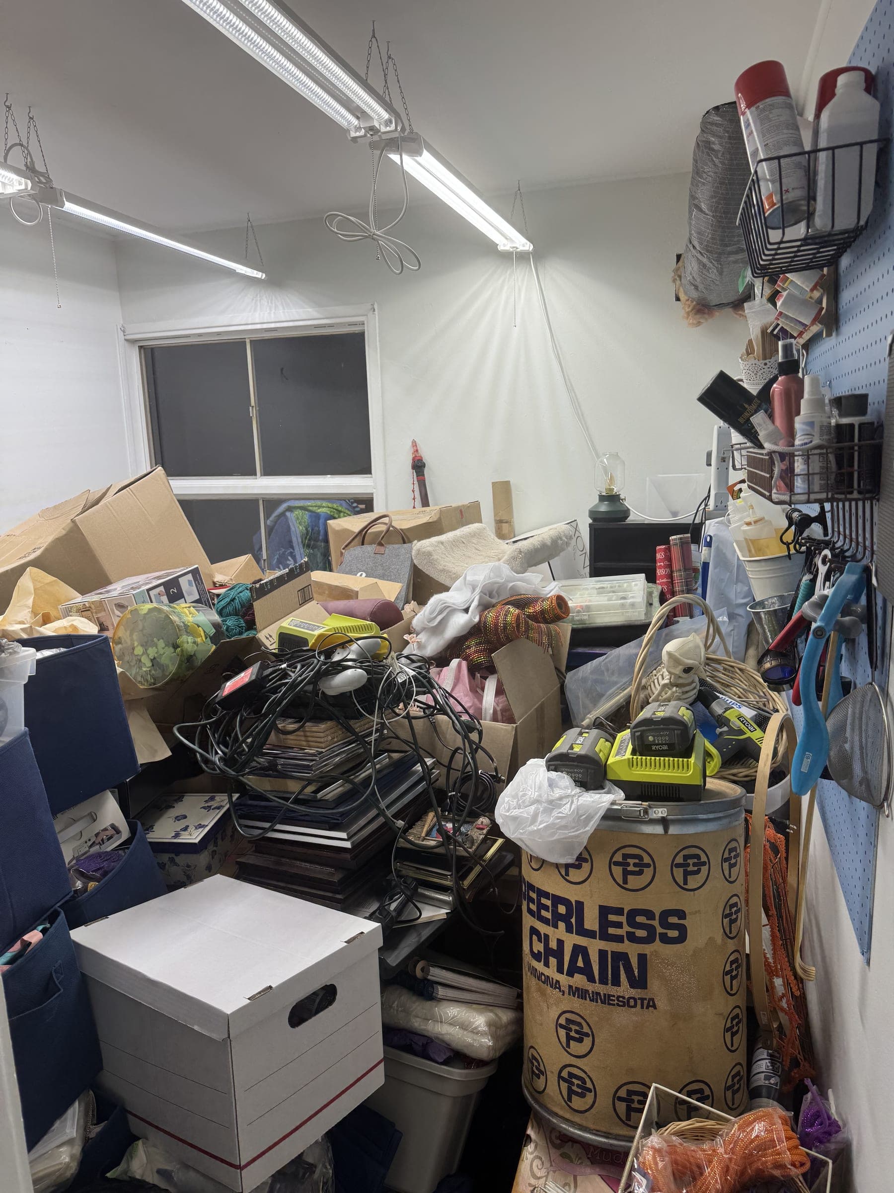 Storage room packed floor to ceiling with loose boxes, bags, and equipment, before pack-up