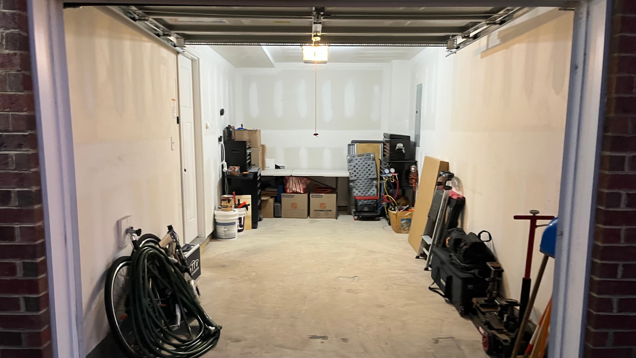 A one-car garage after a CleanSlate transformation, floor cleared end to end and belongings sorted along the walls